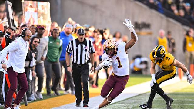 Oct 21, 2023; Iowa City, Iowa, USA; Minnesota Golden Gophers running back Darius Taylor (1) stays in bounds after the catch as Iowa Hawkeyes defensive back Cooper DeJean (3) chases and head coach P.J. Fleck (left) looks on during the third quarter at Kinnick Stadium. 