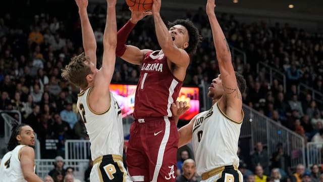 Dec 9, 2023; Toronto, Ontario, CAN; Alabama Crimson Tide guard Mark Sears (1) makes a basket against Purdue Boilermakers forward Mason Gillis (0) and guard Fletcher Loyer (2) during the first half at Coca-Cola Coliseum.