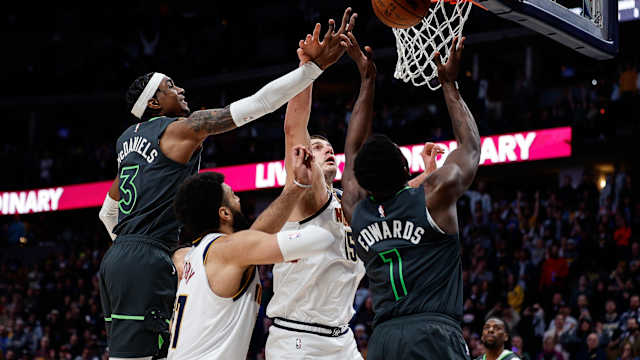 Jan 18, 2023; Denver, Colorado, USA; Denver Nuggets center Nikola Jokic (15) battles for a rebound with Minnesota Timberwolves forward Jaden McDaniels (3) and guard Anthony Edwards (1) as guard Jamal Murray (27) defends in the fourth quarter at Ball Arena.