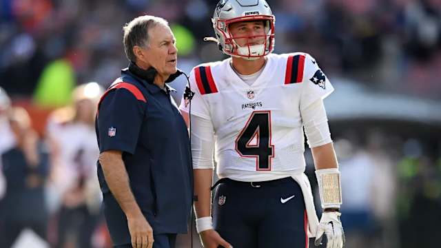 New England Patriots Bill Belichick speaks with quarterback Bailey Zappe