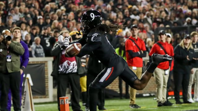 Nov 11, 2022; Cincinnati, Ohio, USA; Cincinnati Bearcats cornerback Arquon Bush (9) attempts to intercept the ball against the East Carolina Pirates in the first half at Nippert Stadium. Mandatory Credit: Katie Stratman-USA TODAY Sports  