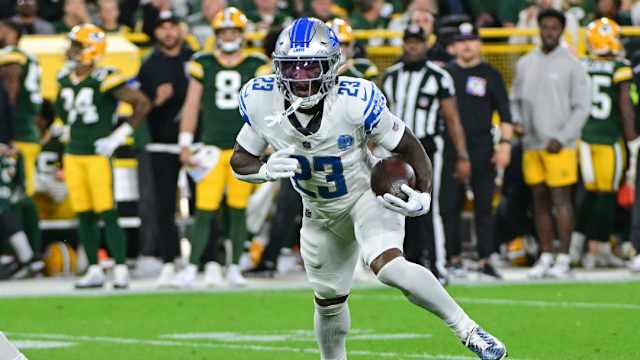 Detroit Lions cornerback Jerry Jacobs runs after intercepting a pass against the Green Bay Packers.