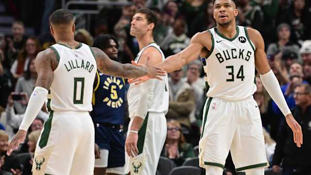 Milwaukee Bucks forward Giannis Antetokounmpo (34) celebrates with Milwaukee Bucks guard Damian Lillard (0) 