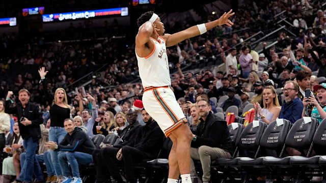Dec 15, 2023; San Antonio, Texas, USA; San Antonio Spurs forward Keldon Johnson (3) reacts after scoring a three pointer during the first half against the Los Angeles Lakers at Frost Bank Center.