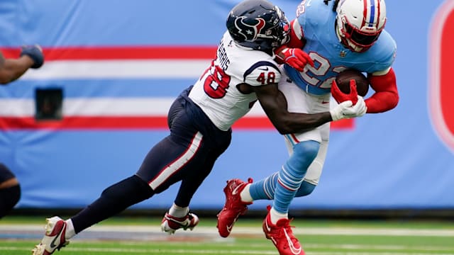 Tennessee Titans running back Derrick Henry (22) is tackled by Houston Texans linebacker Christian Harris (48) during the first quarter at Nissan Stadium in Nashville, Tenn., Sunday, Dec. 17, 2023