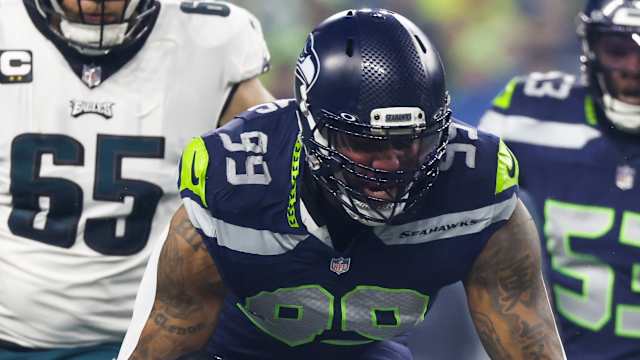 Seattle Seahawks defensive end Leonard Williams (99) tackles Philadelphia Eagles running back D'Andre Swift (0) for a loss during the first quarter at Lumen Field.