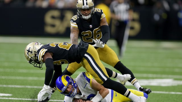New Orleans, Louisiana, USA; Los Angeles Rams quarterback Matthew Stafford (9) slides under a tackle by New Orleans Saints cornerback Paulson Adebo (29)