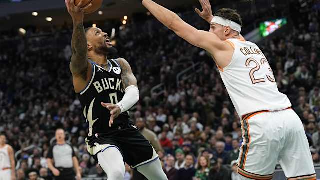 Milwaukee Bucks guard Damian Lillard (0) shoots around San Antonio Spurs center Zach Collins (23)