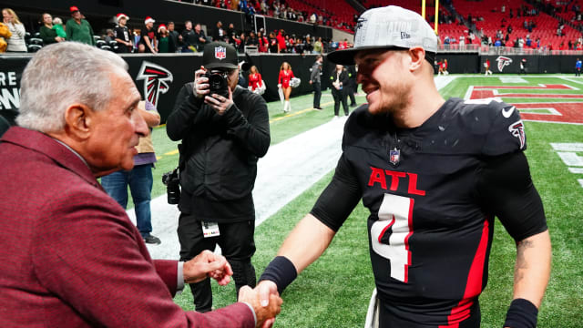 Atlanta Falcons quarterback Taylor Heinicke (4) greets owner Arthur Blank as he walks off the field following the Falcons 29-10 victory over the Indianapolis Colts at Mercedes-Benz Stadium.