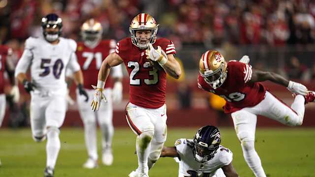 Dec 25, 2023; Santa Clara, California, USA; San Francisco 49ers running back Christian McCaffrey (23) runs the ball pressured by Baltimore Ravens cornerback Brandon Stephens (21) in the second quarter at Levi's Stadium. Mandatory Credit: Cary Edmondson-USA TODAY Sports
