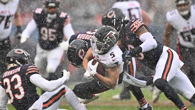 Dec 31, 2023; Chicago, Illinois, USA; Atlanta Falcons wide receiver Drake London (5) is tackled by Chicago Bears defensive back Jaylon Johnson (33), defensive back Kyler Gordon (6) and linebacker Tremaine Edmunds (49) after a short pass gain in the first half at Soldier Field.
