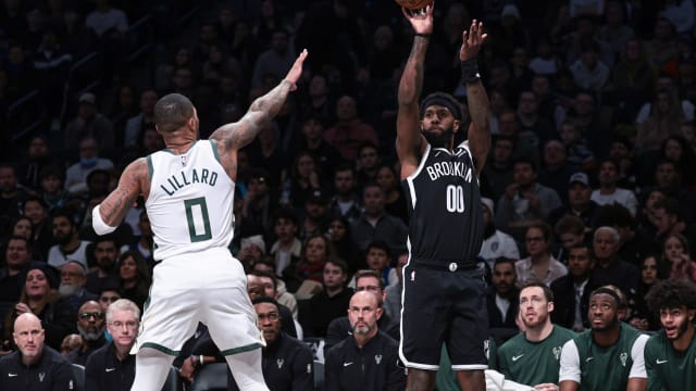 Brooklyn Nets forward Royce O'Neale (00) shoots the ball as Milwaukee Bucks guard Damian Lillard (0)