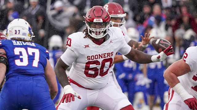 Oklahoma Sooners offensive lineman Tyler Guyton (60) at the line of scrimmage against the Kansas Jayhawks during the game at David Booth Kansas Memorial Stadium.