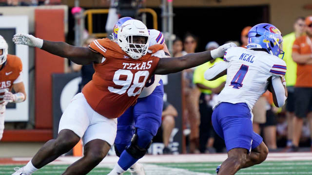 Sep 30, 2023; Austin, Texas, USA; Texas Longhorns defensive lineman Trill Carter (98) reaches for Kansas Jayhawks running back Devin Neal (4) during the second half at Darrell K Royal-Texas Memorial Stadium. Mandatory Credit: Scott Wachter-USA TODAY Sports  