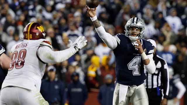 Dallas Cowboys quarterback Dak Prescott (4) passes the ball as Washington Commanders defensive tackle Phidarian Mathis (98) defends during the fourth quarter at FedExField.