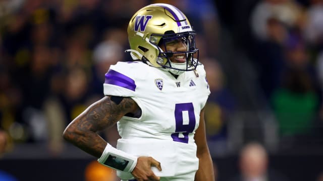 Washington QB Michael Penix Jr. grimaces in pain during CFP title game