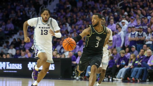 Jan 6, 2024; Manhattan, Kansas, USA; UCF Knights guard Darius Johnson (3) runs away from Kansas State Wildcats center Will McNair Jr. (13 and guard Cam Carter (5) during the second half at Bramlage Coliseum.