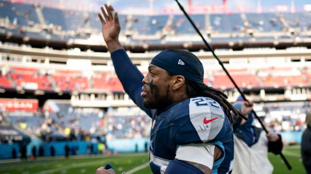 Titans running back Derrick Henry waves to the crowd as he runs off the field.