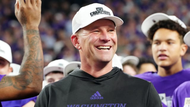 Washington Huskies head coach Kalen DeBoer reacts as players celebrate after the Huskies defeated the Oregon Ducks 31-34 to win the Pac-12 Championship at Allegiant Stadium.
