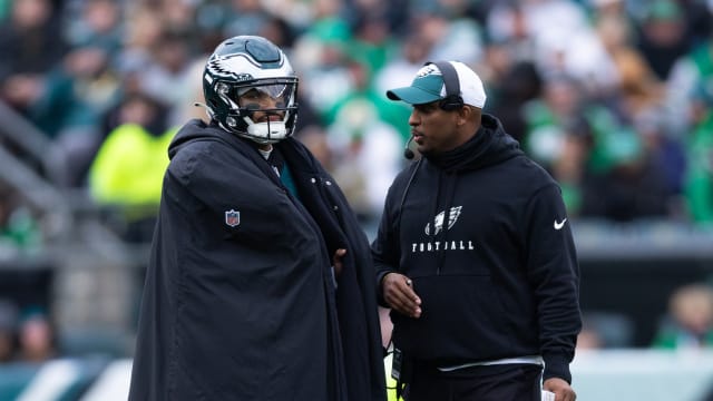 Dec 31, 2023; Philadelphia, Pennsylvania, USA; Philadelphia Eagles quarterback Jalen Hurts (L) and offensive coordinator Brian Johnson (R) talks during a timeout in the second quarter against the Arizona Cardinals at Lincoln Financial Field. Mandatory Credit: Bill Streicher-USA TODAY Sports