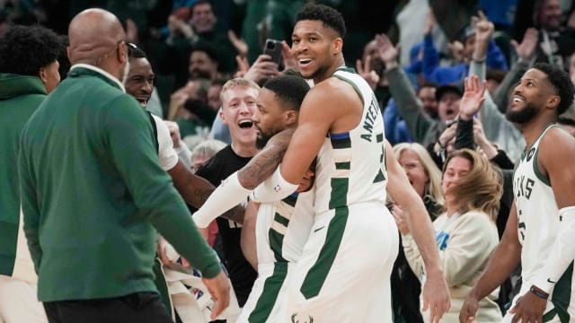 Bucks guard Damian Lillard gets a hug from Giannis Antetokounmpo 
