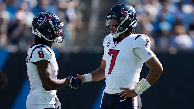 Houston Texans wide receiver John Metchie III (8) shakes hands with quarterback C.J. Stroud (7) during a time out to check for a touchdown run during the second quarter against the Carolina Panthers at Bank of America Stadium.