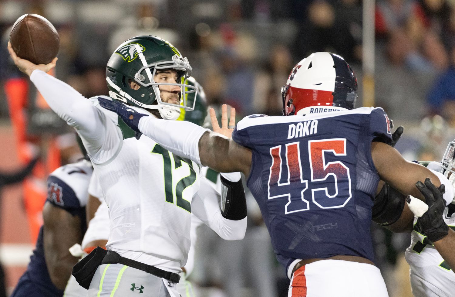 Feb 18, 2023; Houston, TX, USA; Orlando Guardian quarterback Quinten Dormady (12) throws a pass against Houston Roughnecks linebacker John Dana (45) in the fourth quarter at TDECU Stadium. Mandatory Credit: Thomas Shea-USA TODAY Sports  