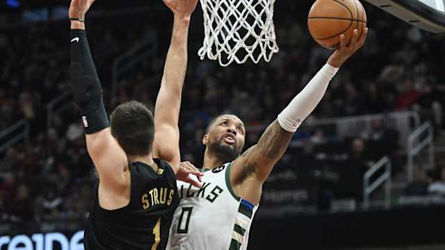 Milwaukee Bucks guard Damian Lillard (0) drives to the basket against Cleveland Cavaliers guard Max Strus (1)