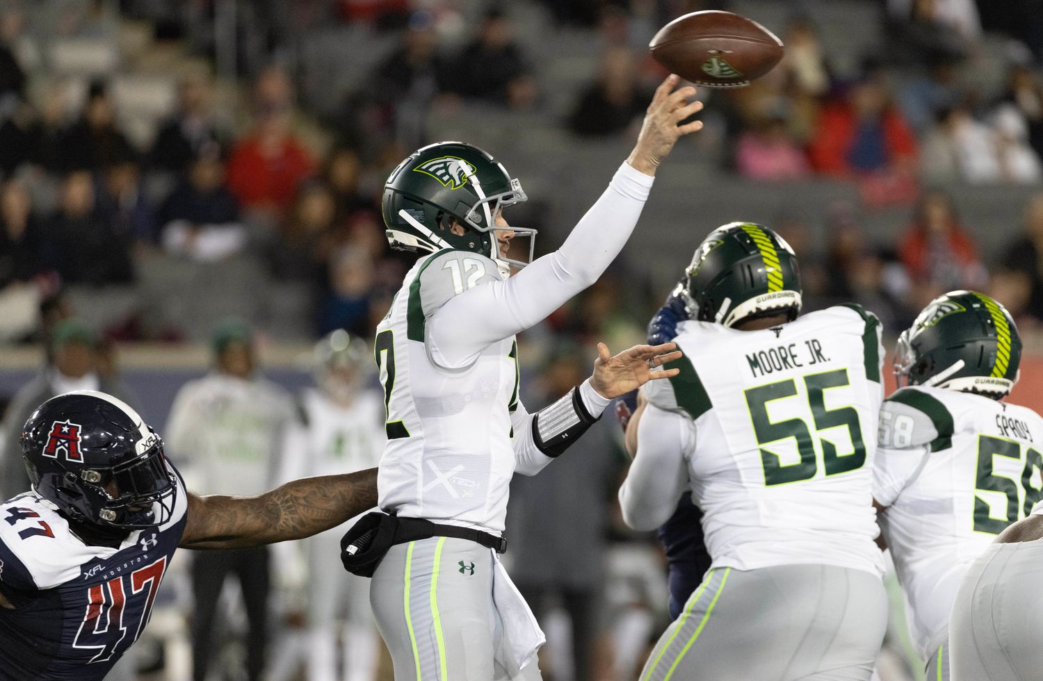 Feb 18, 2023; Houston, TX, USA; Orlando Guardian quarterback Quinten Dormady (12) throws a pass against Houston Roughnecks linebacker Chaucey Rivers (47) in the fourth quarter at TDECU Stadium. Mandatory Credit: Thomas Shea-USA TODAY Sports  