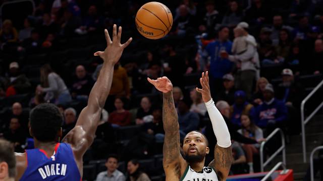 Milwaukee Bucks guard Damian Lillard (0) shoots on Detroit Pistons center Jalen Duren (0)