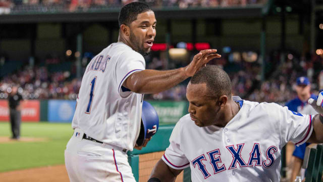 Texas Rangers shortstop Elvis Andrus, left, touches the head of third baseman Adrian Beltre after Beltre hit a home run against the Toronto Blue Jays in June 2017 at Globe Life Park in Arlington.