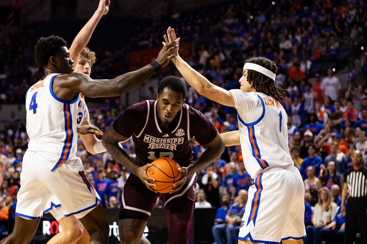 Mississippi State Bulldogs forward Jimmy Bell Jr. (15) attempts to shoot a layup over Florida Gators forward Tyrese Samuel (4) and guard Walter Clayton Jr. (1) during the first half at Exactech Arena at the Stephen C. O'Connell Center.
