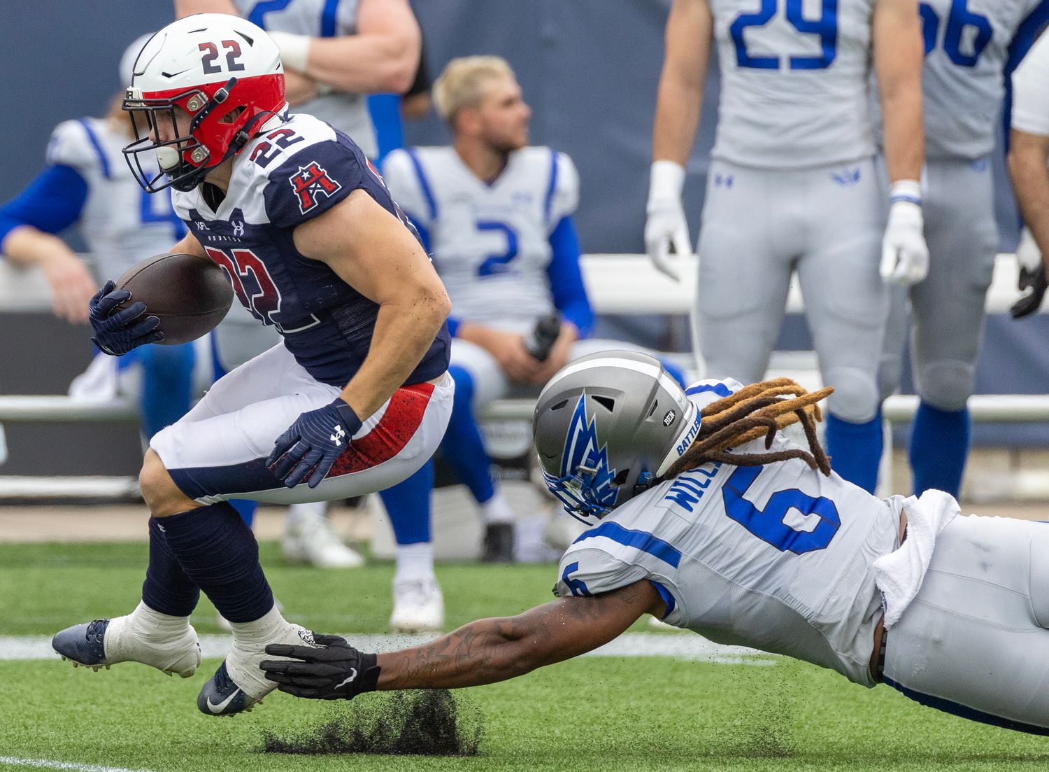 Apr 2, 2023; Houston, TX, USA; Houston Roughnecks running back Max Borghi (22) breaks the tackle of St. Louis Battlehawks linebacker Lake Williams (9) in the second quarter at TDECU Stadium. Mandatory Credit: Thomas Shea-USA TODAY Sports  