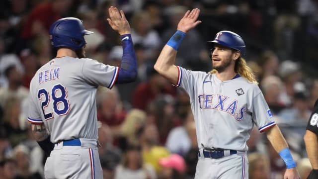 Texas Rangers outfielder Travis Jankowski, right, celebrates Marcus Semien's three-run home run in Game 4 of the World Series with Jonah Heim. Jankowski re-signed a one-year, $1.7 million deal with the club for the 2024 season.