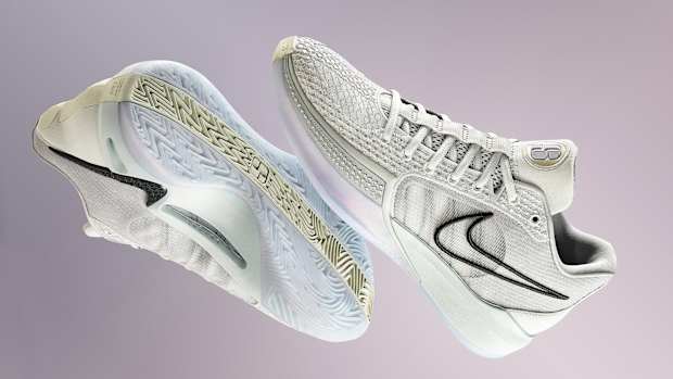 Side view of Sabrina Ionescu's white and black Nike basketball shoes.