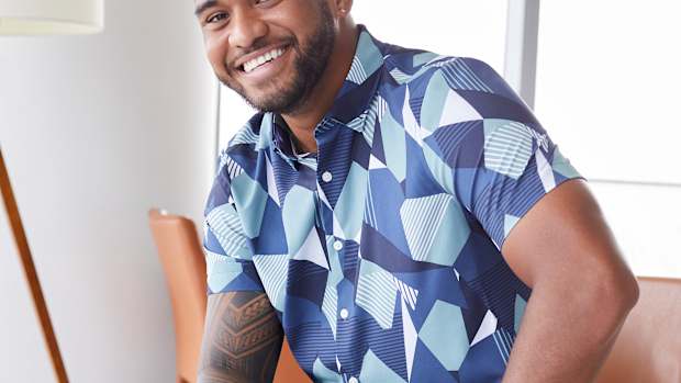 Tua Tagovailoa modeling a blue Perry Ellis shirt.