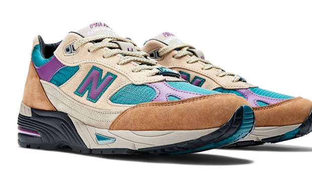 Side view of brown, purple, and teal New Balance shoes.