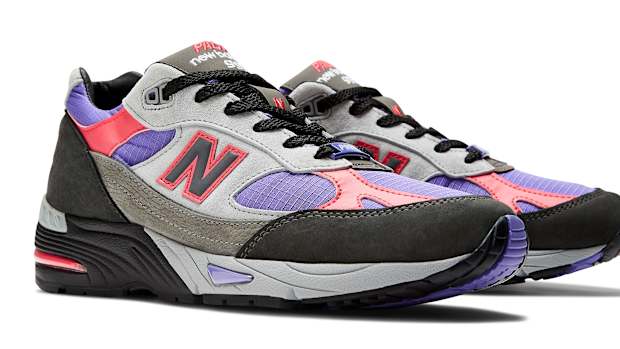 Side view of grey, purple, and black New Balance shoes.