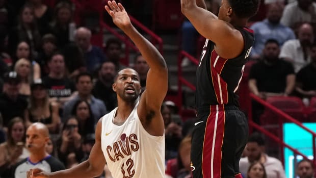 Dec 8, 2023; Miami, Florida, USA; Miami Heat guard Kyle Lowry (7) shoots over Cleveland Cavaliers center Tristan Thompson (12) during the second half at Kaseya Center.
