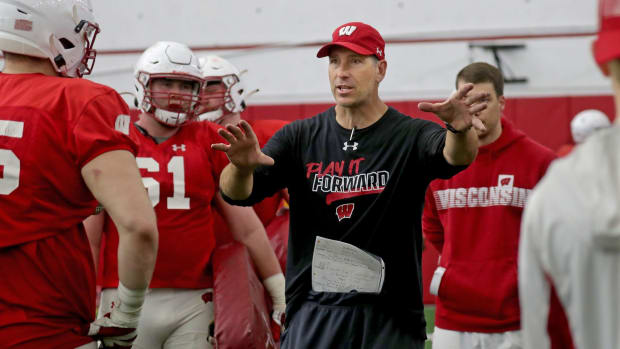 Offensive Line coach Bob Bostad, works with his players the during the University of Wisconsin spring football practice at Camp Randall Stadium in Madison.