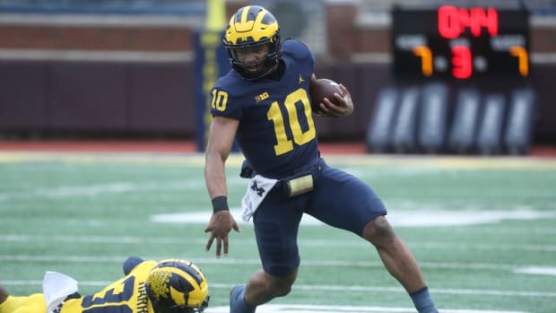 Michigan Wolverines quarterback Alex Orji runs with the ball.