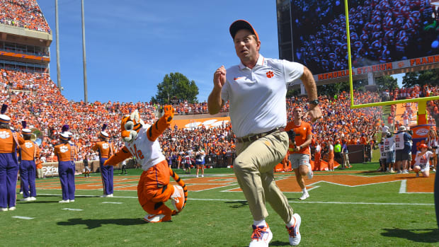 Clemson Tigers head coach Dabo Swinney runs on the field before a game.