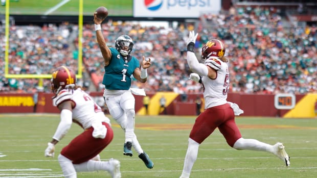 Washington Commanders defend a pass from Philadelphia Eagles quarterback, Jalen Hurts (1).