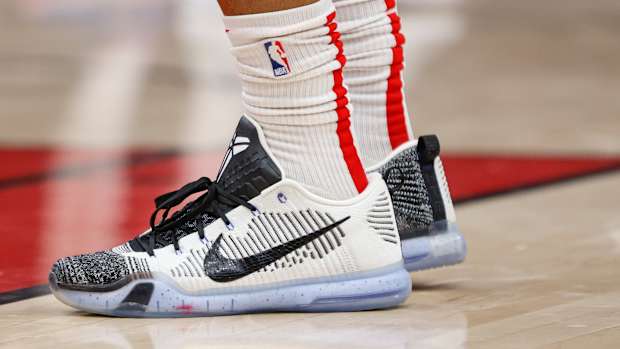 View of white and black Nike Kobe shoes.