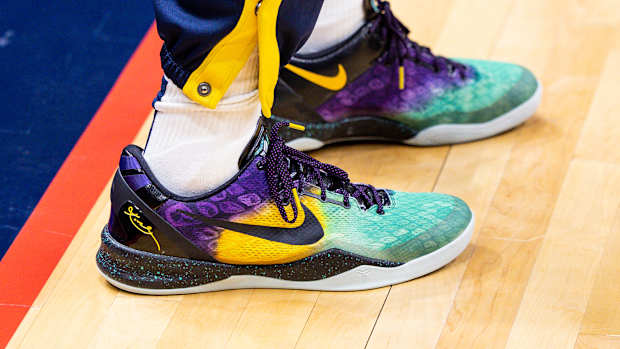 View of black, yellow, and teal Nike Kobe shoes.