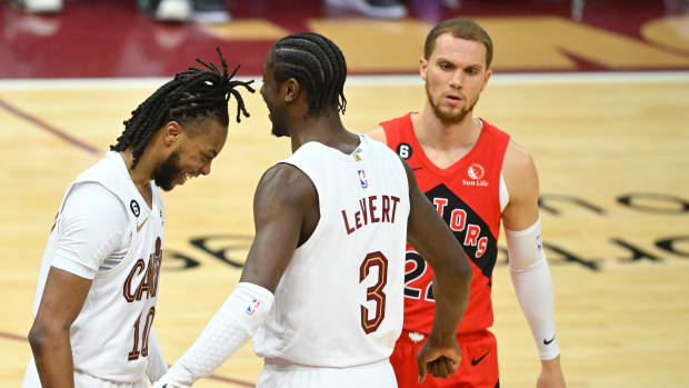 Feb 26, 2023; Cleveland, Ohio, USA; Cleveland Cavaliers guard Darius Garland (10) and guard Caris LeVert (3) celebrate beside Toronto Raptors guard Malachi Flynn (22) in the fourth quarter at Rocket Mortgage FieldHouse. Mandatory Credit: David Richard-USA TODAY Sports