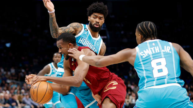 Mar 12, 2023; Charlotte, North Carolina, USA; Cleveland Cavaliers forward Evan Mobley (4) drives through Charlotte Hornets guard Dennis Smith Jr. (8) and center Nick Richards (4) during the first half at Spectrum Center. Mandatory Credit: Brian Westerholt-USA TODAY Sports