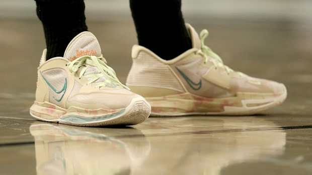 View of Kyrie Irving's tan Nike shoes.