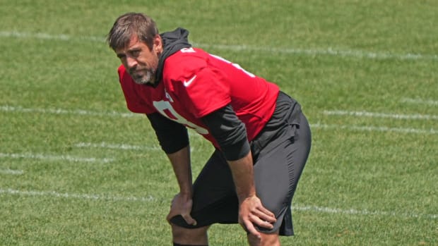 Aaron Rodgers takes a knee during New York Jets training camp.