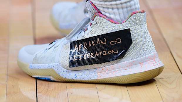 View of Kyrie Irving's white and pink Nike shoes.